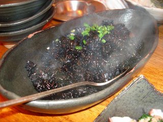 [photo: steaming squid ink rice]
